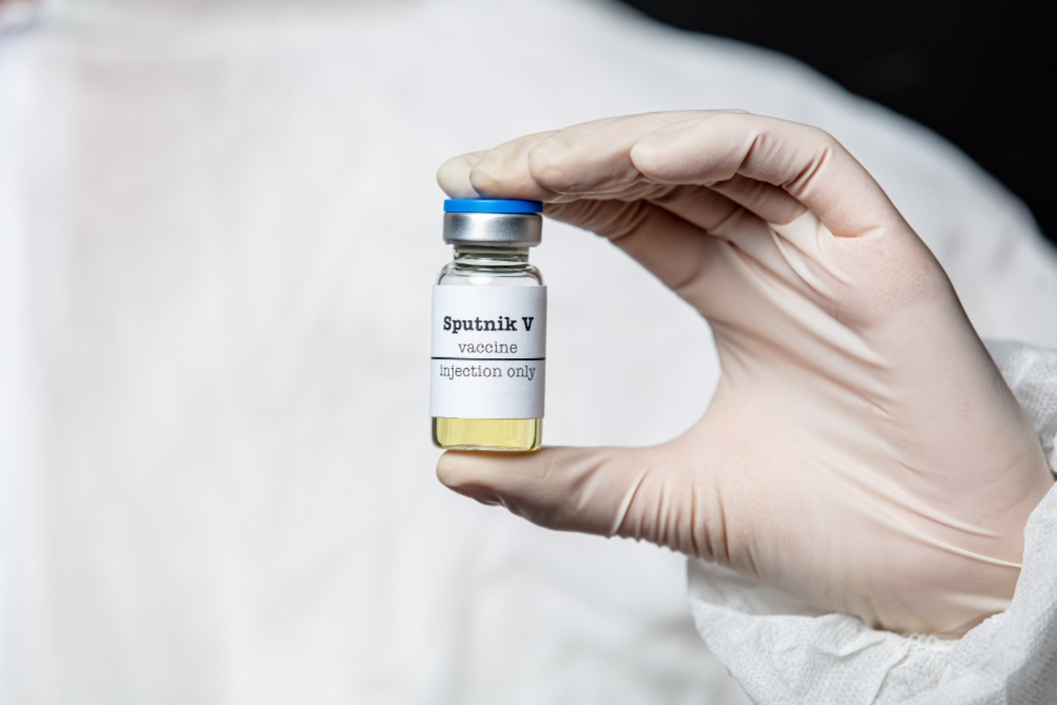 COVID 19 Vaccine Sputnik medic-hold-vaccine-container-with-russian-sputnik-v (1)