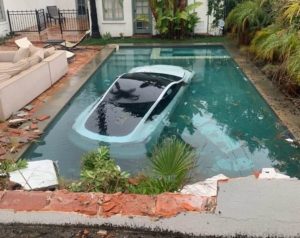 Tesla crashes into swimming pool (1) (1)